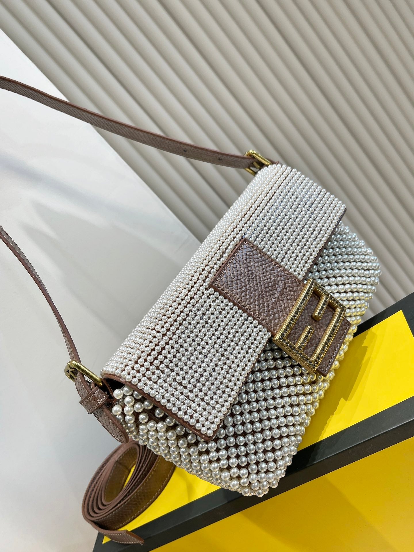 Elegant Textured Weave Baguette Shoulder Bag with Gold-Tone Buckle - Cream and Black